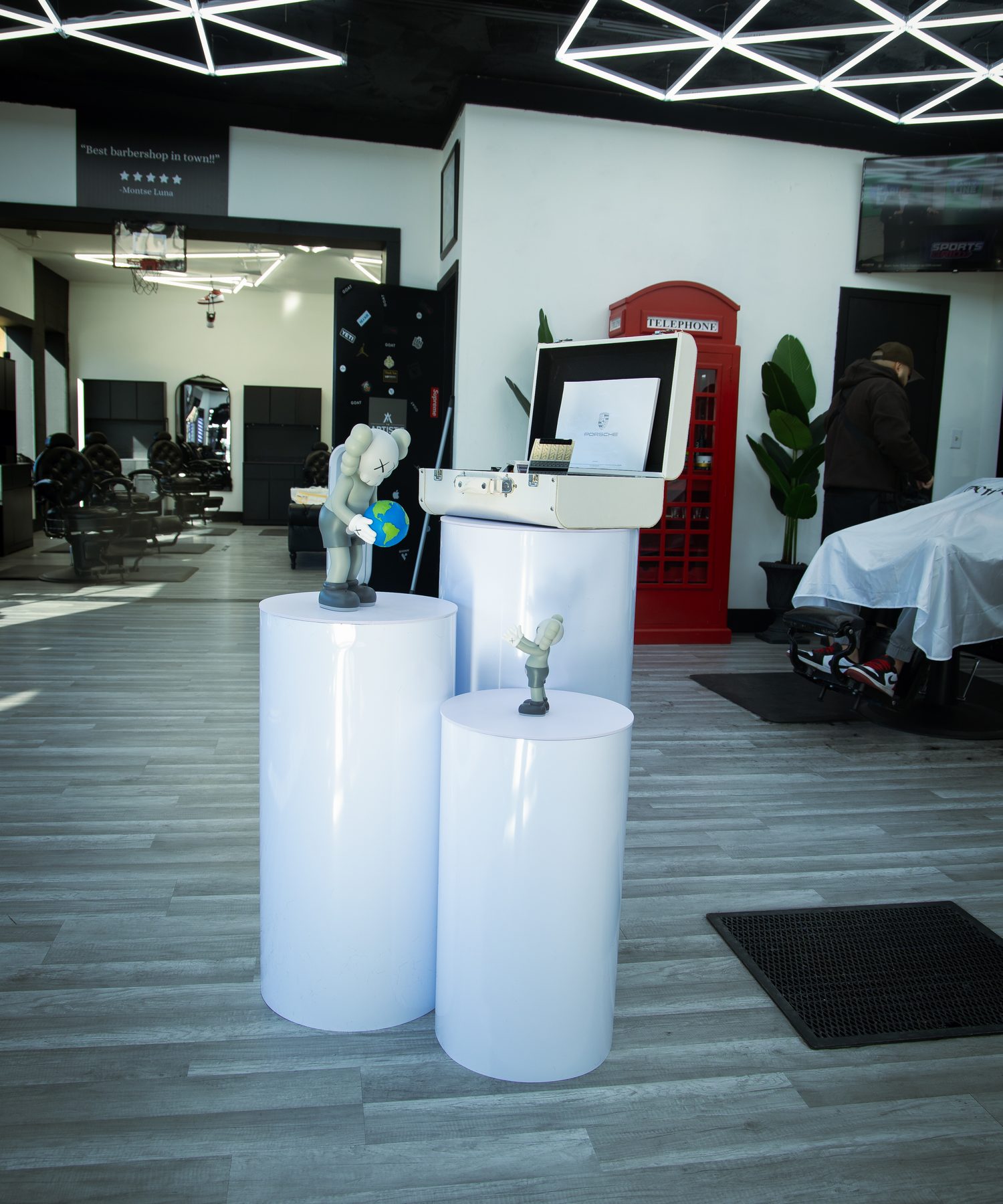 Collectible figures displayed on lit white plinths on the shop floor